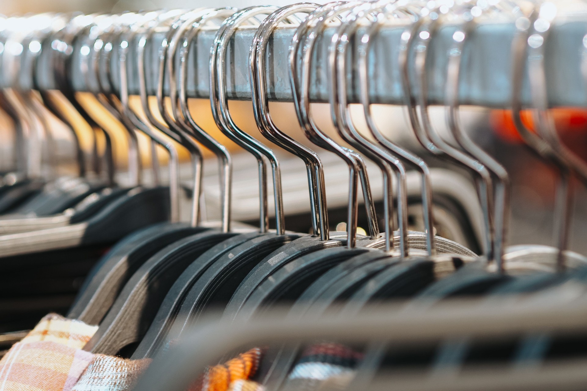 close up of rows of hangers in a shopping area, selective focus