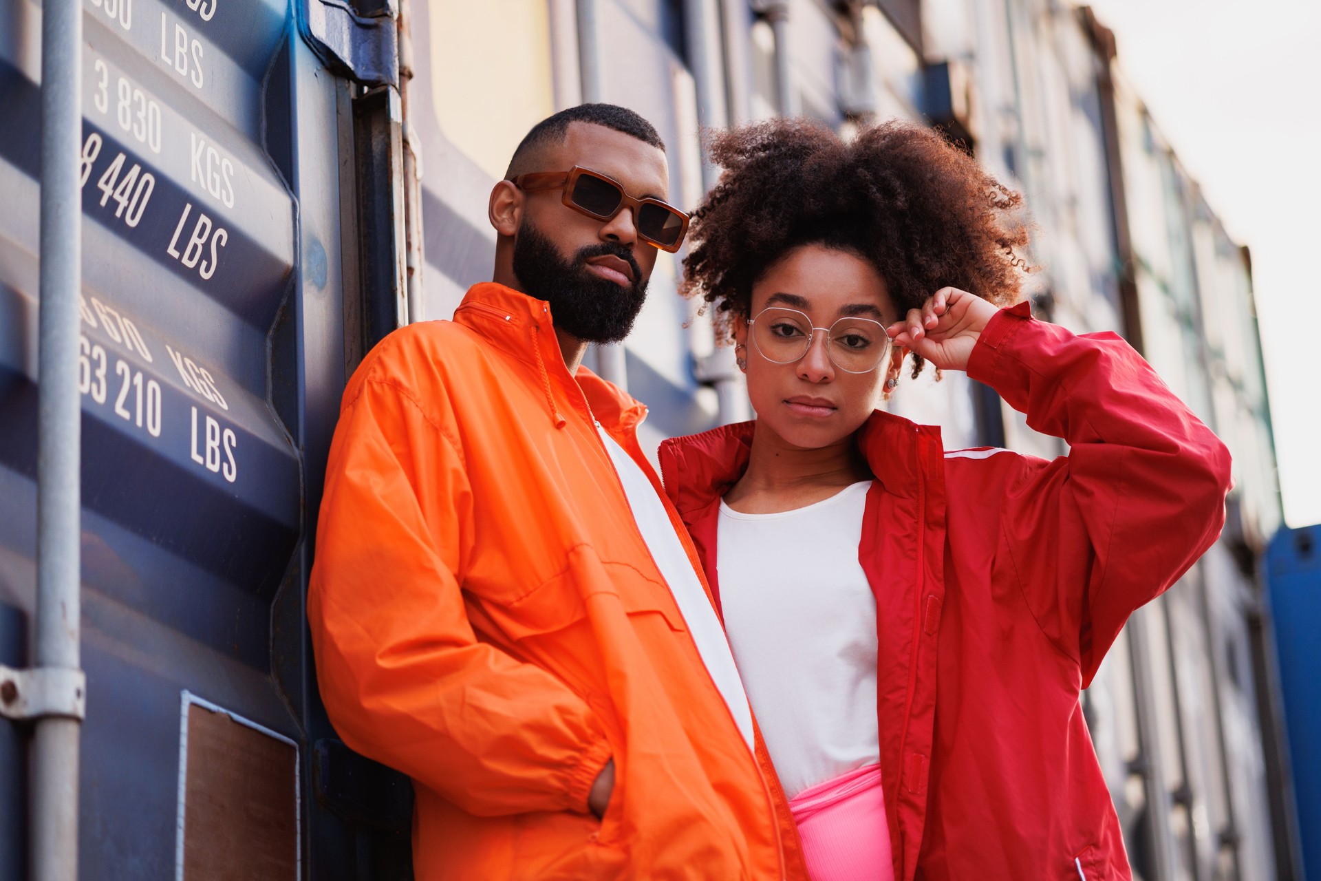 Portrait of african american couple in sunglasses standing near cargo container